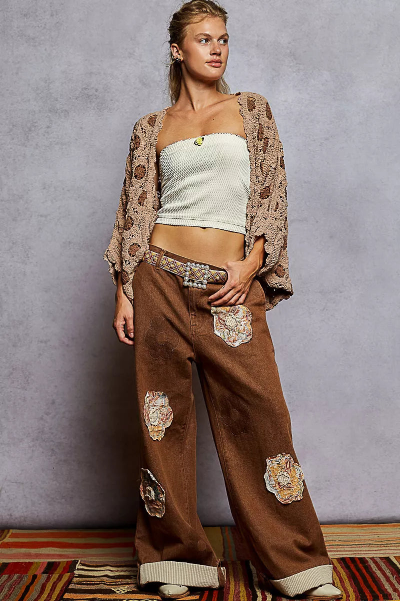beige crochet chenille cardigan with floral crochet, layered over crop top and patch pants for a luxe fall look