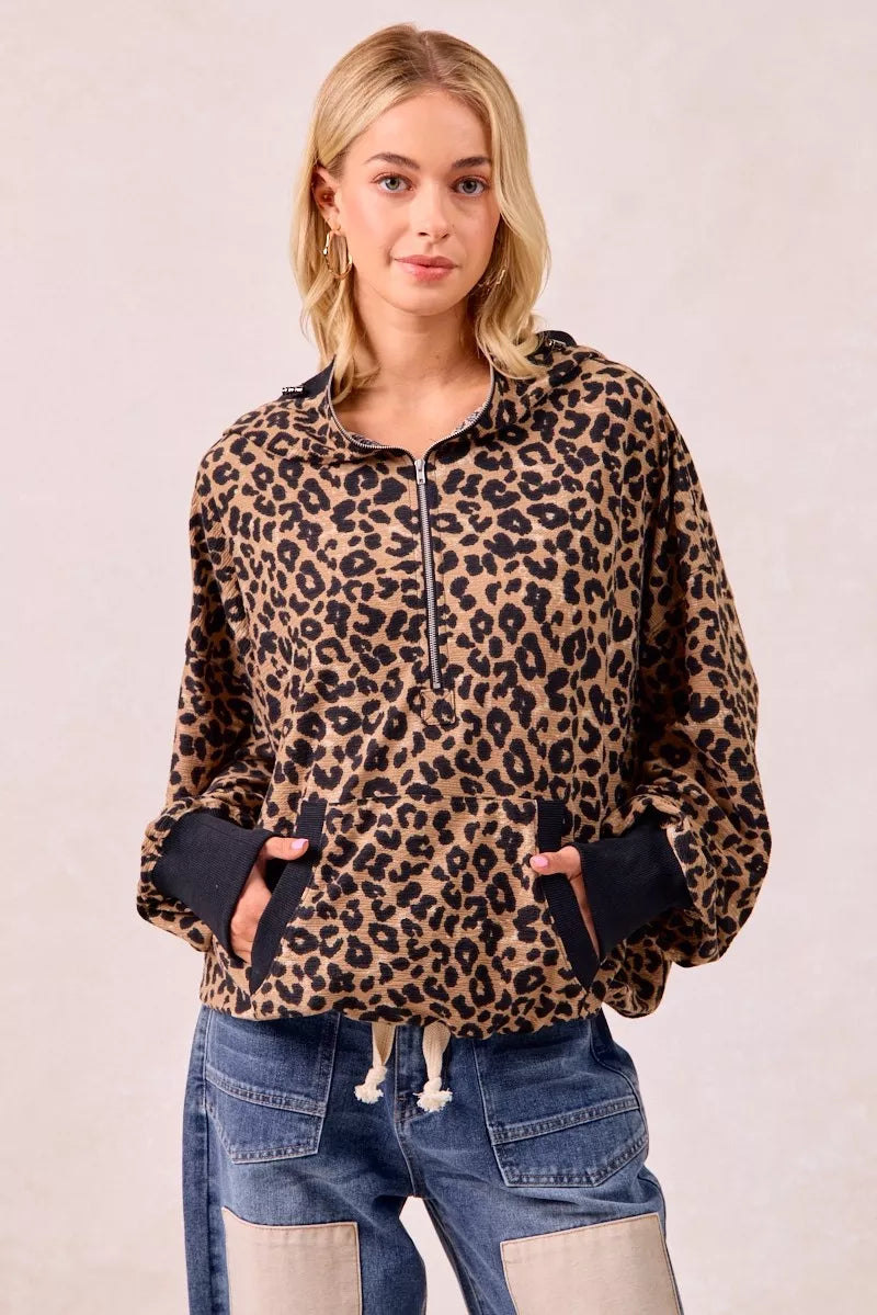 Leopard print waffle knit half zip pullover hoodie styled with jeans for casual boho-luxe everyday look.