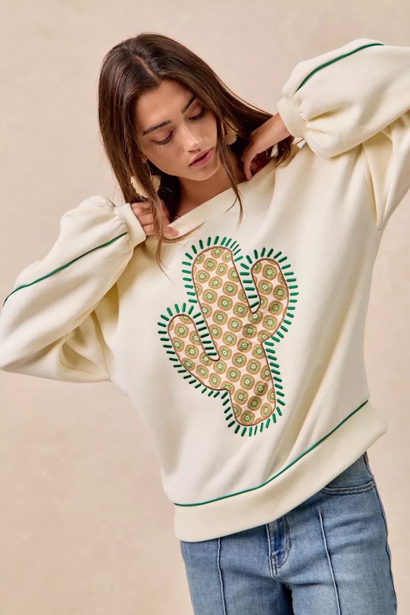 Southwestern cactus patch sweatshirt with balloon sleeves and contrast piping in cream soft fleece fabric