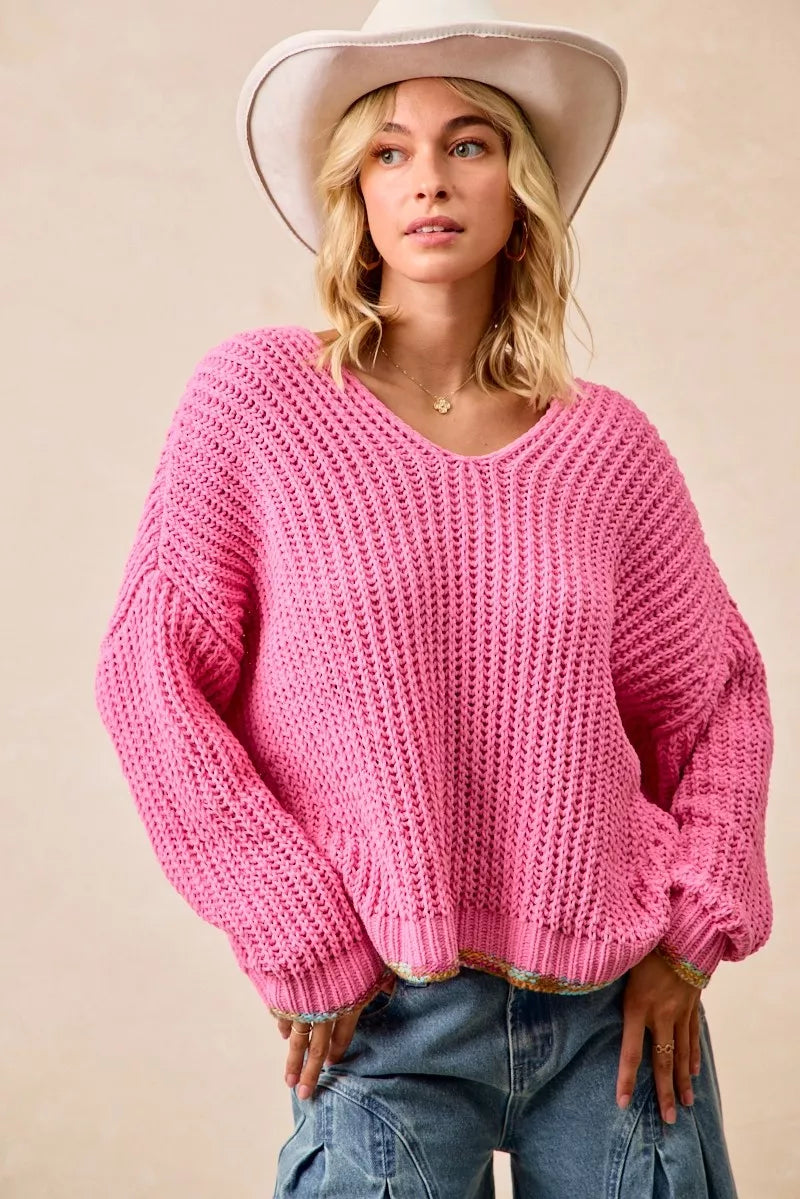 Bubblegum pink chunky knit sweater with colorful trim and relaxed oversized fit for cozy everyday style