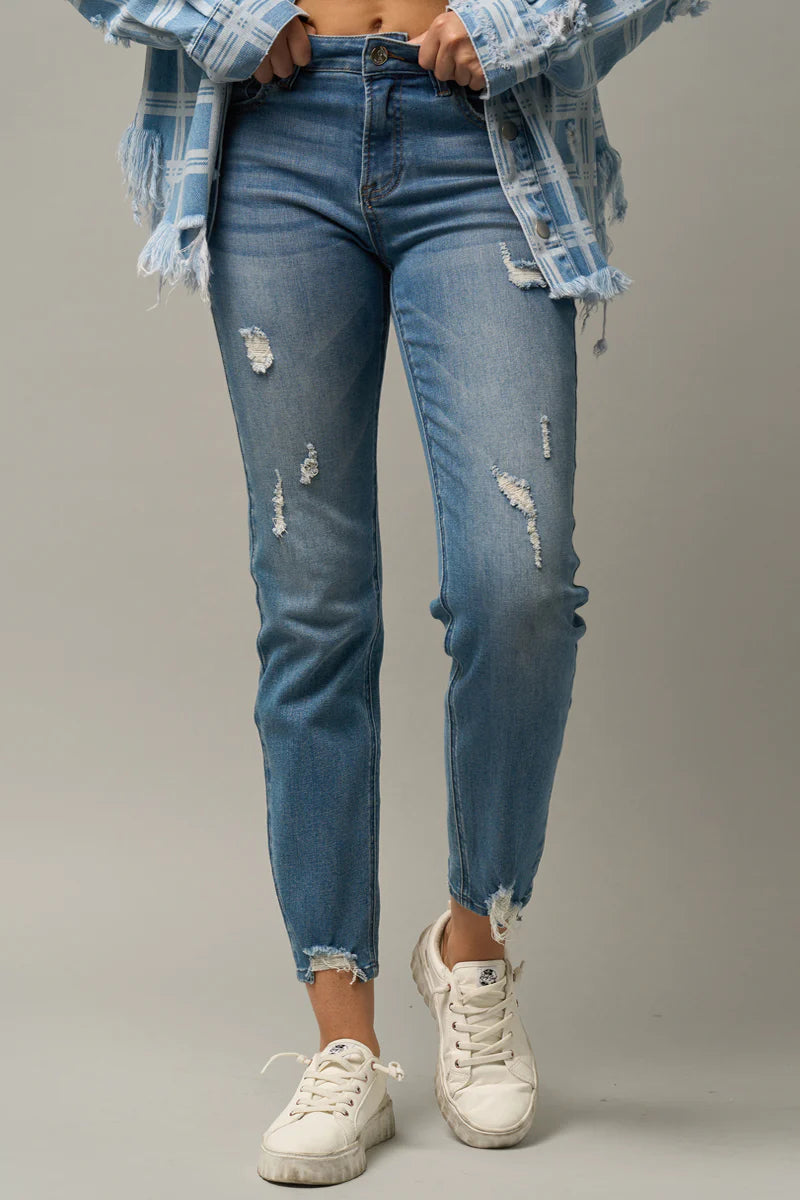 Medium Wash Girlfriend Silhouette Relaxed Slim Fit Cropped Length Distressed with Raw Hems Button + Zip Closure Stretch Jeans