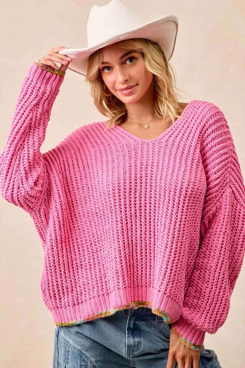 Oversized bubblegum pink v neck sweater with confetti trim, dropped shoulders and slouchy, comfy fit