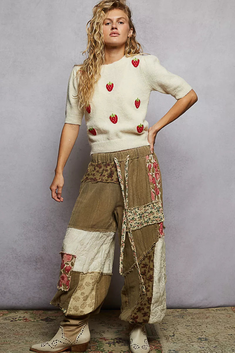Strawberry patch cream knit sweater styled with patchwork joggers and
boots for dressy casual fall style