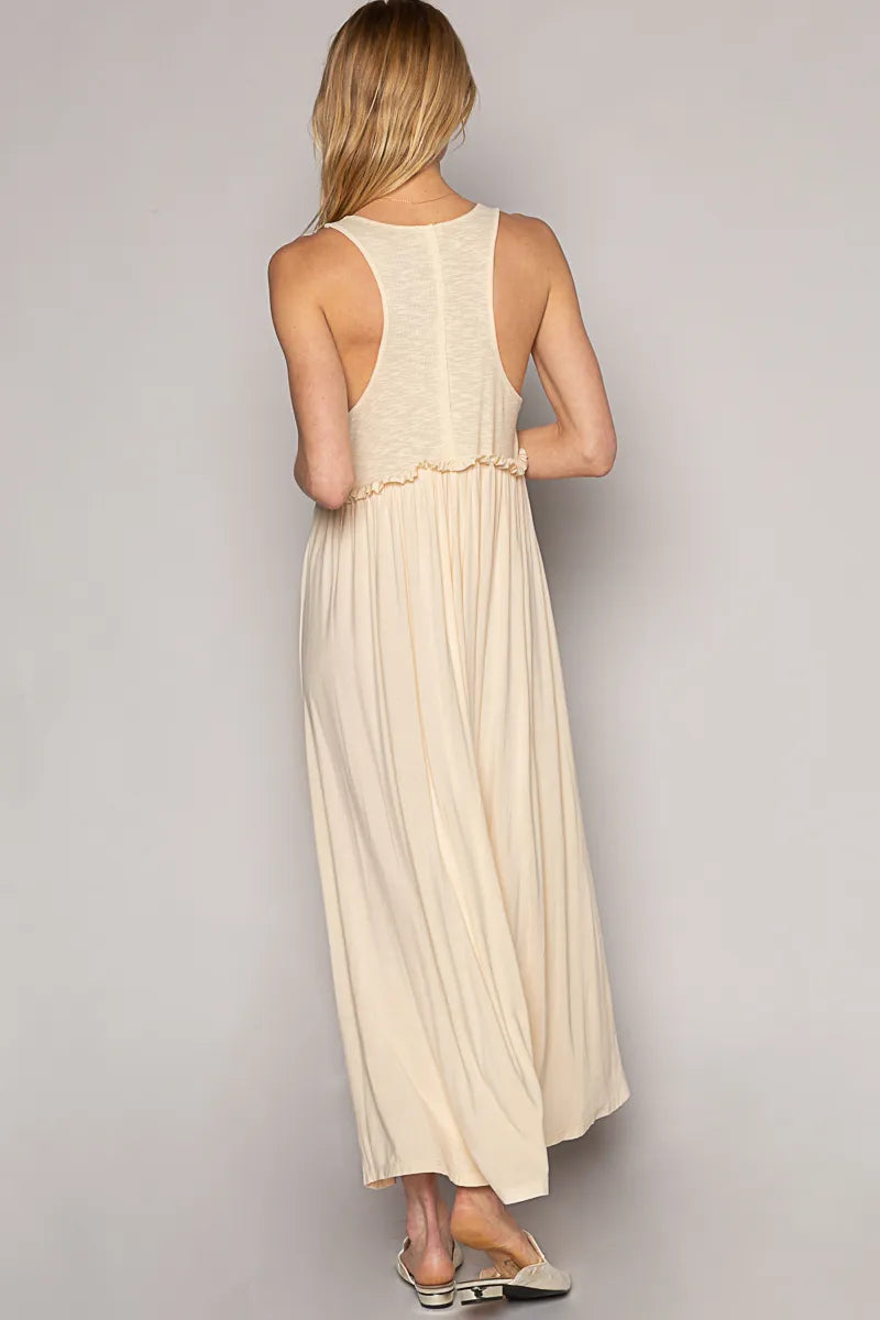 Back view of POL Saltwater Siren Maxi Dress in cream rayon jersey with racerback cut, gathered waist, and twin slits—styled with metallic sandals for coastal elegance.