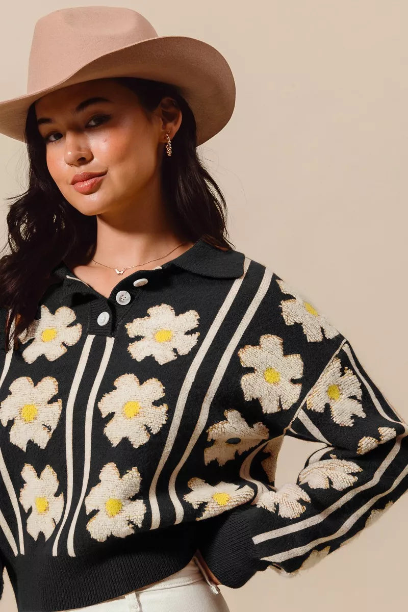 Black knit polo sweater with ivory daisy flowers and striped details