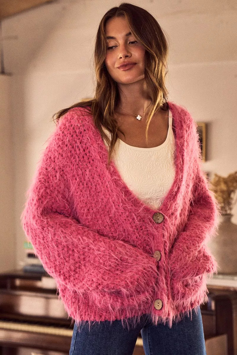 Pink long sleeve fuzzy eyelash cardigan with button front and soft plush knit texture for cozy statement layering looks.
