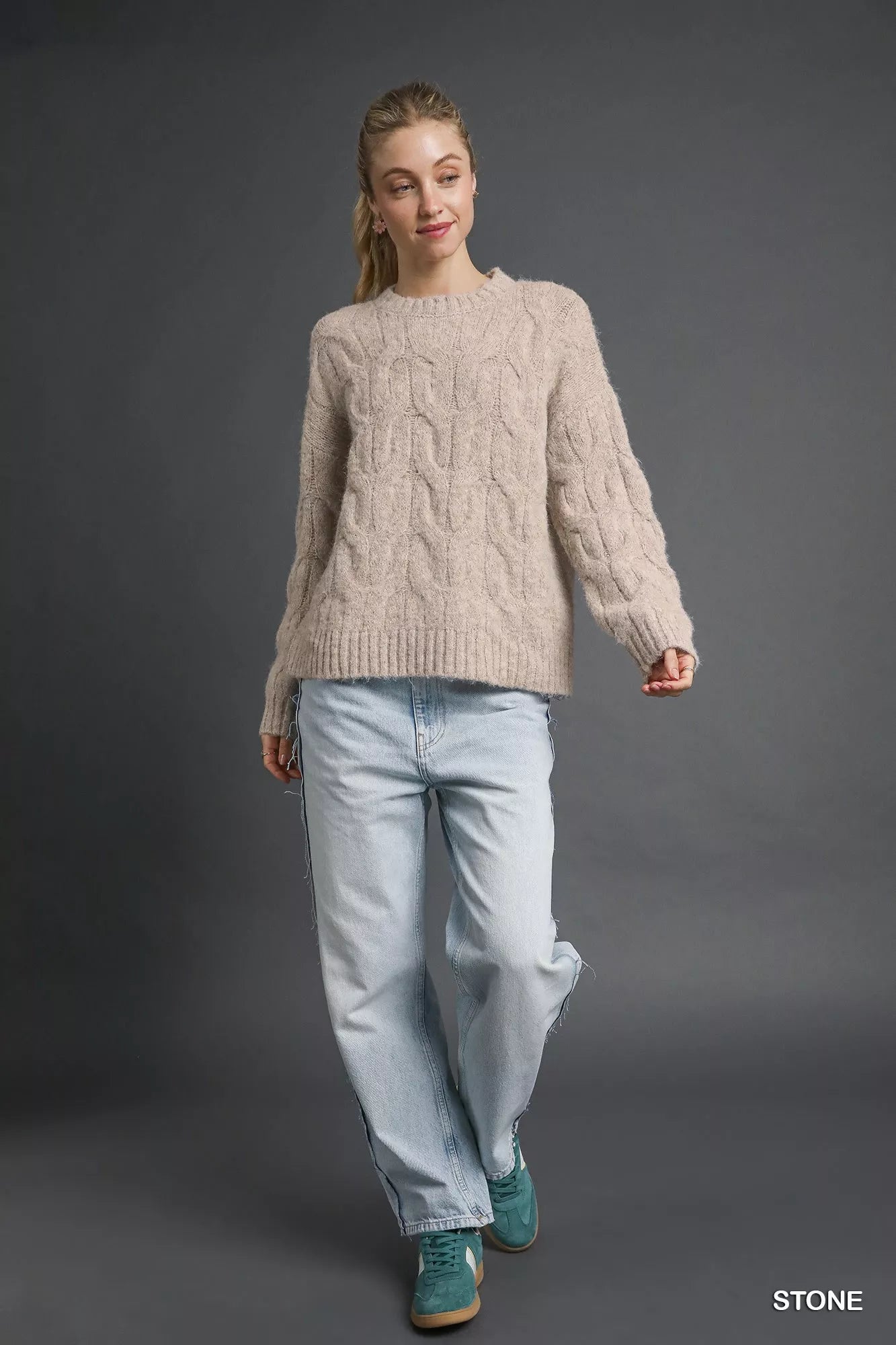 Solid beige brushed cable knit sweater styled with denim, women’s long sleeve crew neck pullover for day to night wear