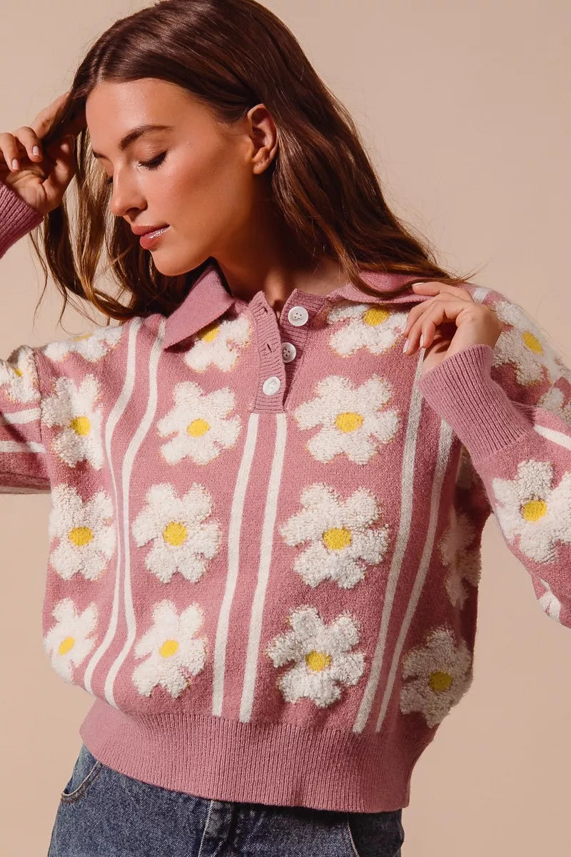 Pink knit polo sweater with white daisy flowers and striped detail