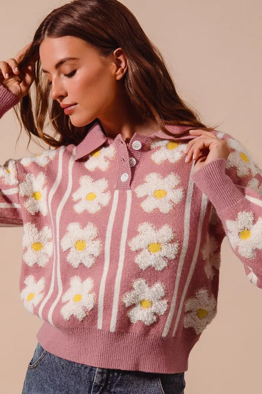 Pink knit polo sweater with white daisy flowers and striped detail