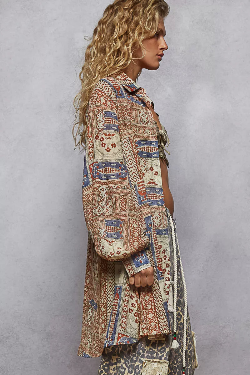 Side view of oversized longline button-up with patchwork print and balloon sleeves in neutral tones