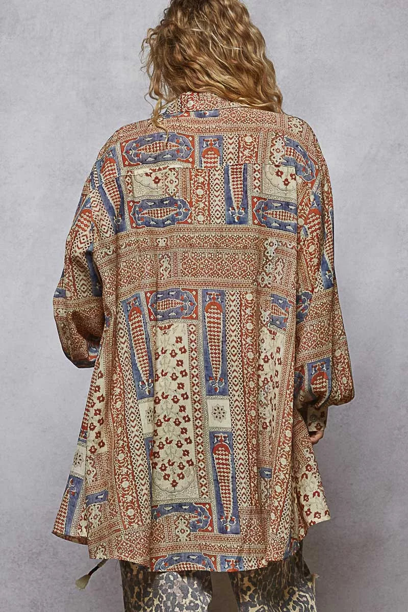 Back view of multicolor patchwork print longline button-up with balloon sleeves