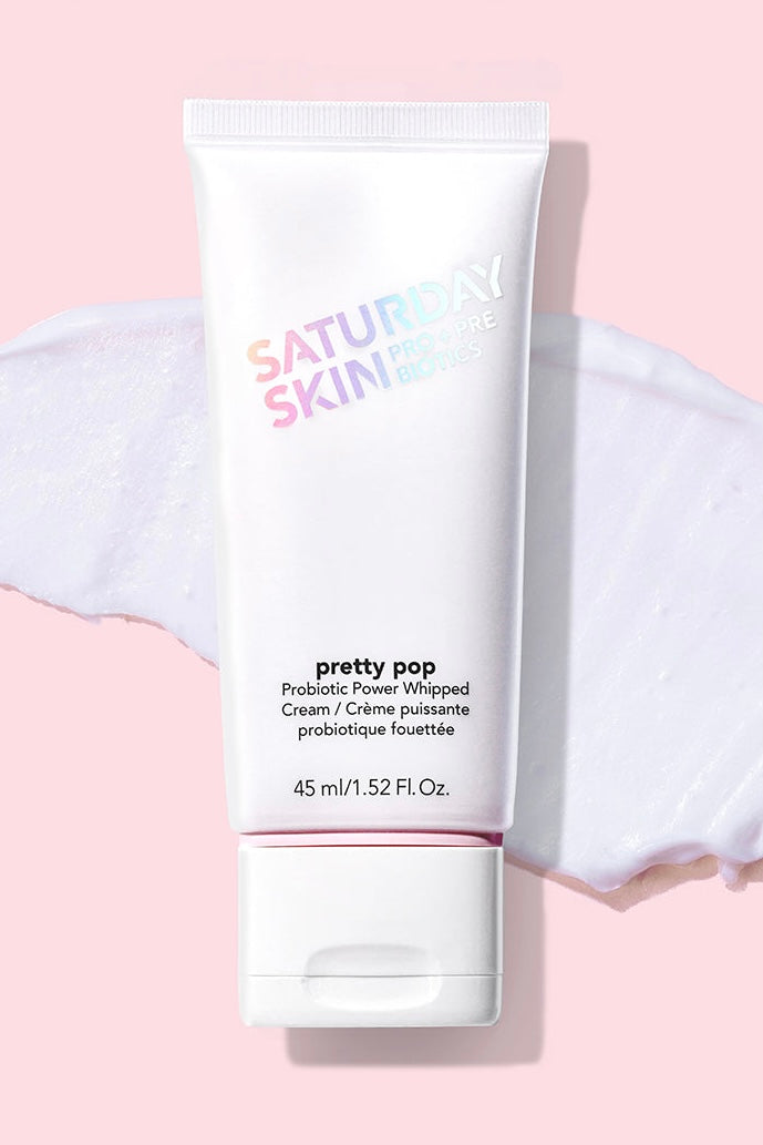 Saturday Skin Pretty Pop Probiotic Power Whipped Cream moisturizer, 45 ml tube with probiotic skincare formula on pink background.