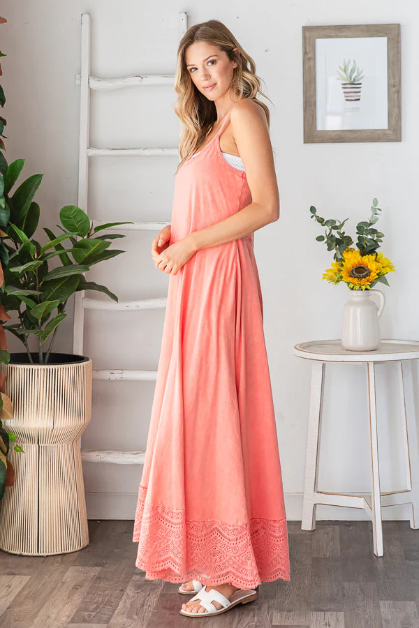 Side view of model in coral wide leg jumpsuit, showcasing lace trim detail at hem and flowy fit.