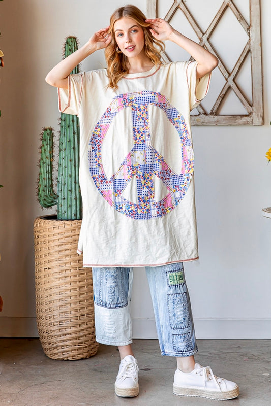 Relaxed True To Size Fit Mineral Washed Multi Floral Print Peace Sign Patch Back Upper Left Peace Sign Patch Contrast Stitching Crew Neck Pockets Bottom Side Slits Can be Worn as a Long Tee or to the Beach