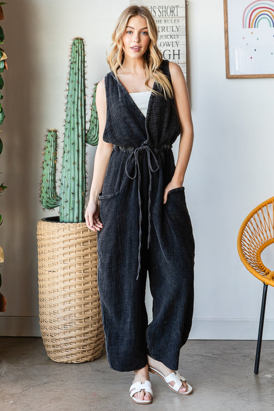 Oli & Hali V Neck Elastic Waist Washed Cotton Hooded Jumpsuit  Slouchy, Relaxed True To Size Fit Pull-On Style Mineral Washed Elastic Waist with Self Tie Detail Sleeveless with Dropped Armholes Oversized Pouch Pockets Straight Wide Leg