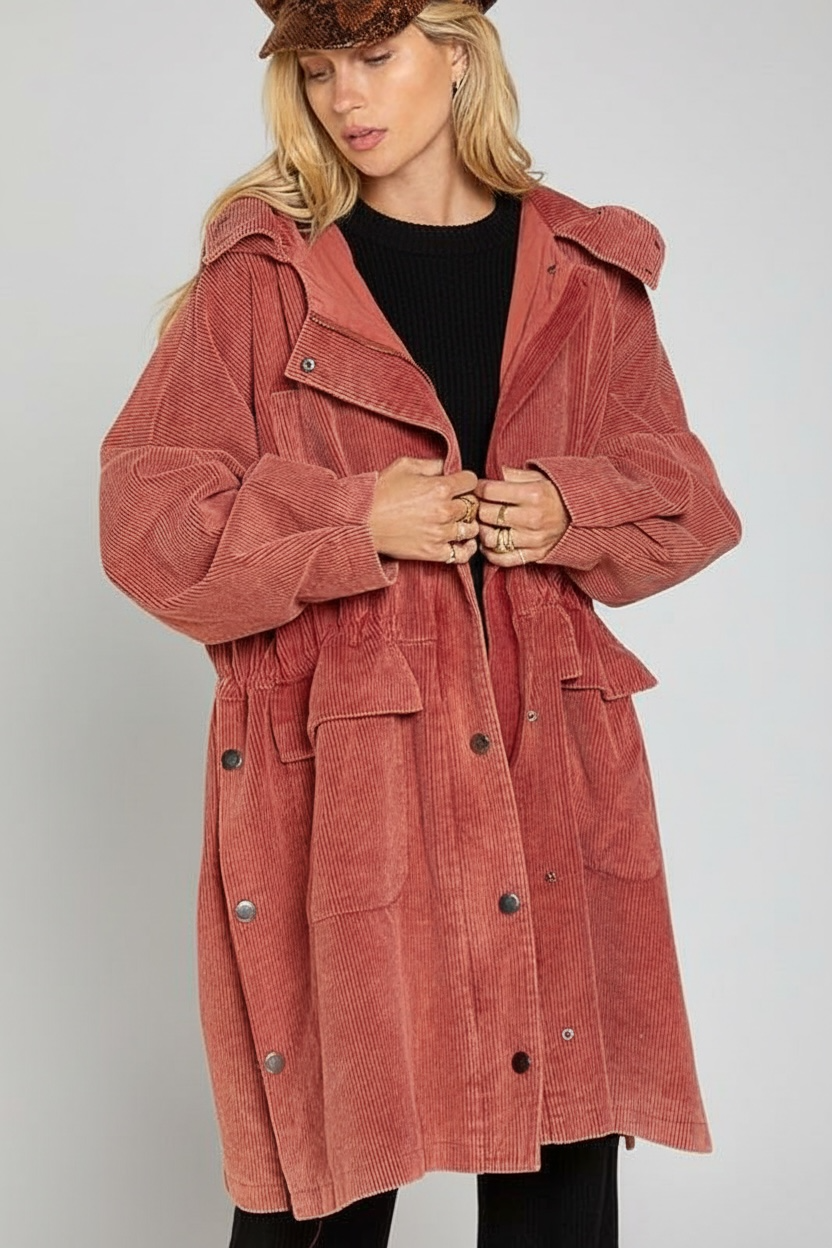 rust corduroy long coat with oversized relaxed fit, hood, snap zip front, and large flap pockets for off duty weekend fall and winter layering 