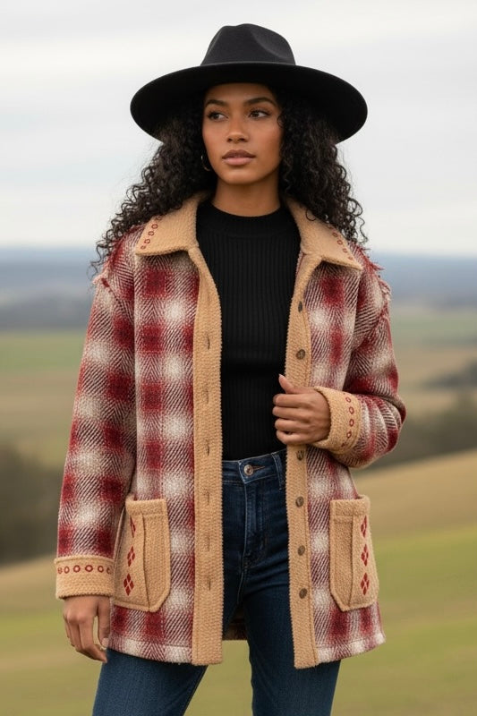 Oversized red plaid jacket with sherpa trim styled with boots for a boho western inspired winter outfit.