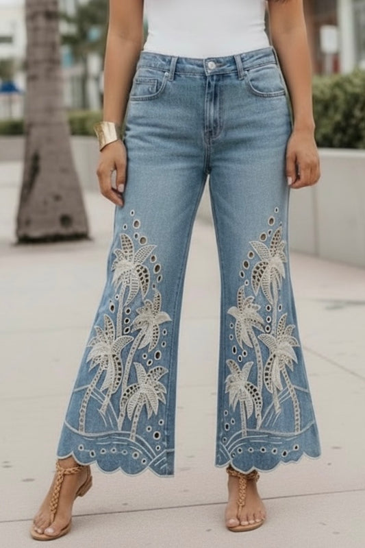 Statement boho embroidered palm tree flare jeans in medium dark mineral wash denim with scalloped hems and tan sandals
