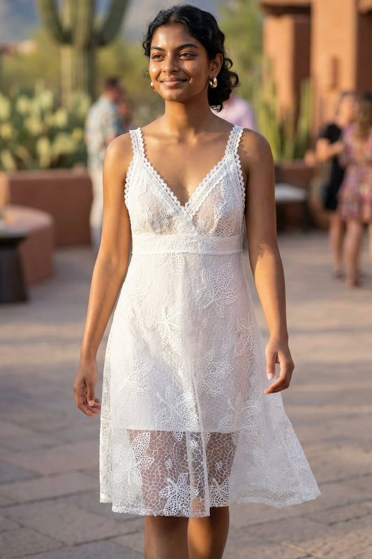 White floral lace plunge neck midi dress with crochet straps, sheer floral lace overlay, and fitted bodice at a desert resort