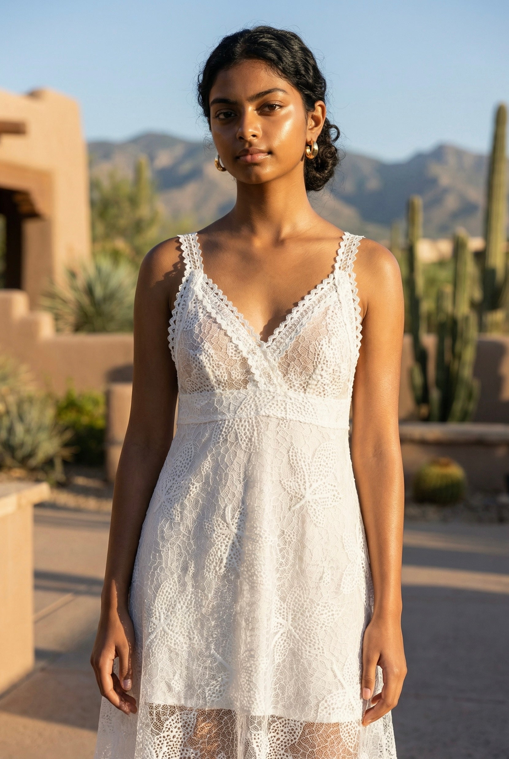 White floral lace plunge neck midi dress close up with crochet straps, fitted floral lace bodice, and desert mountain backdrop