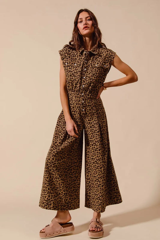 Sleeveless leopard jumpsuit with wide-leg silhouette, ankle-length hem, collared neckline, and blush platform sandals.