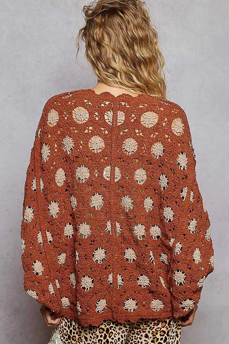 Back view of plush chenille crochet cardigan with center seam, relaxed fit, and floral detail
