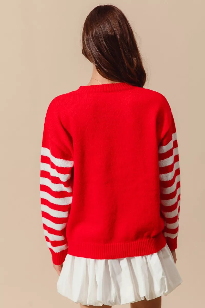 red knit sweater with white striped sleeves, relaxed oversized silhouette shown from back