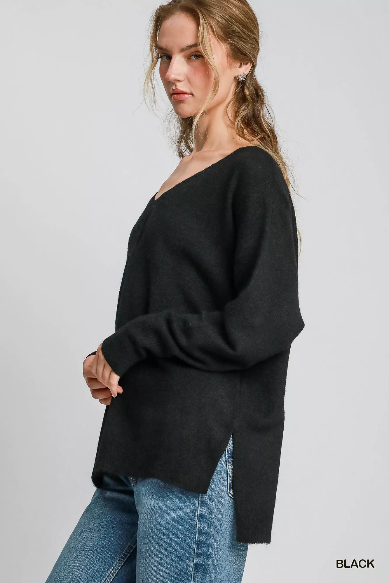 Long sleeve V neck wool blend sweater, women’s black pullover knit with hi-lo hem and side slit detail for chic modern looks