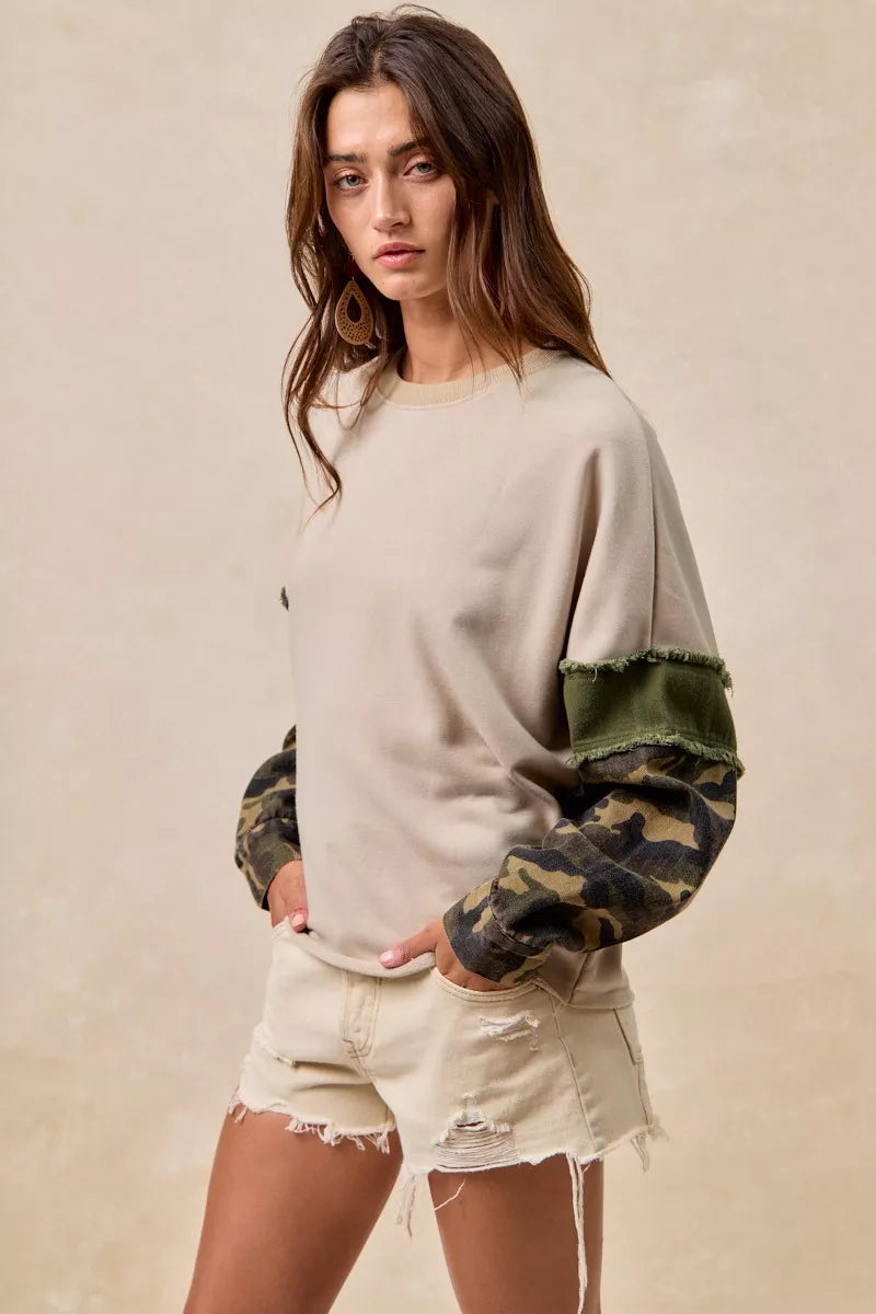 Soft, slouchy French terry pullover in taupe with camo contrast sleeves and raw edge detail for effortless style