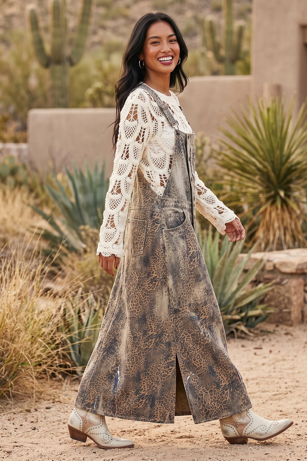 Faded animal print denim overall dress with side hem slit and hip pocket in a profile walking stride