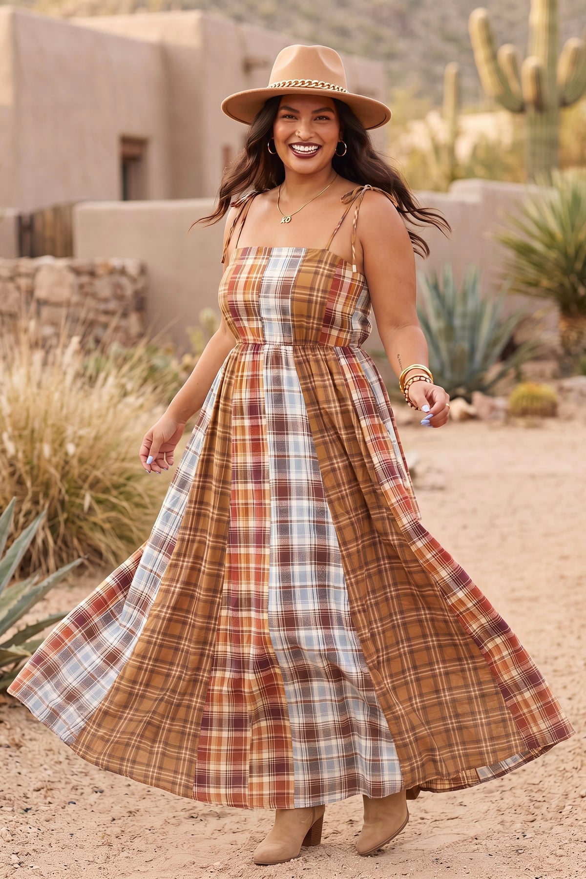 Mixed plaid boho maxi dress with a full skirt, mid twirl with suede boots on a desert path