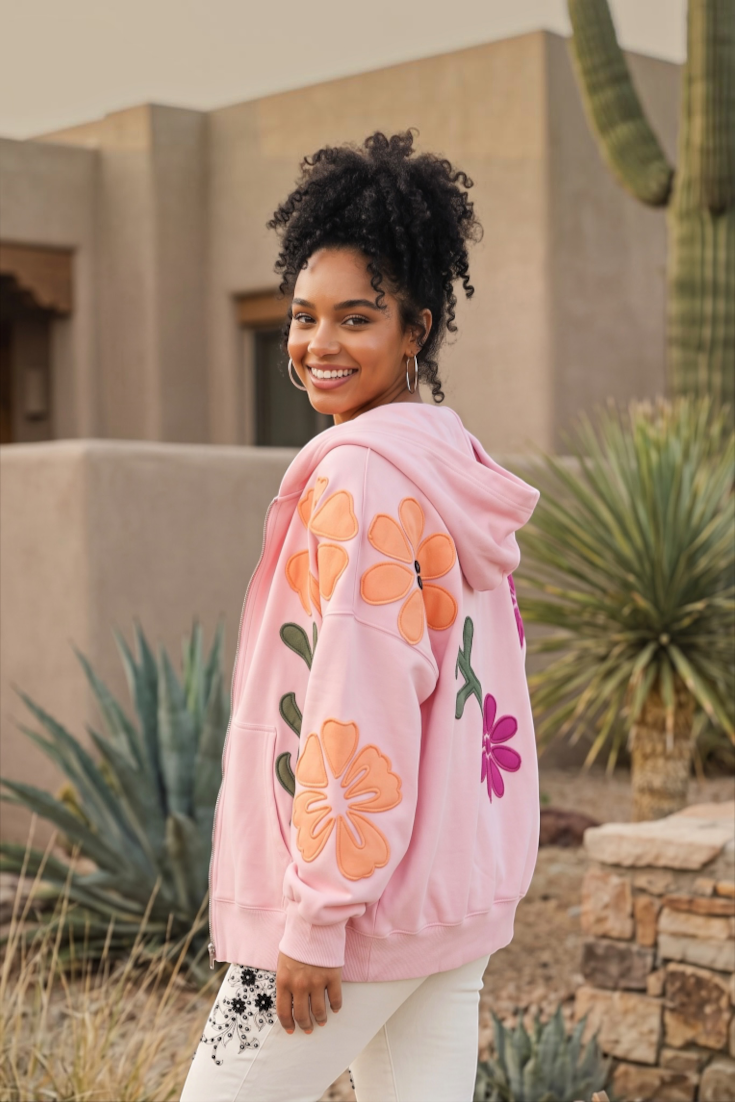Slouchy pink floral patchwork zip up jacket showing bold contrast sleeve appliqués
