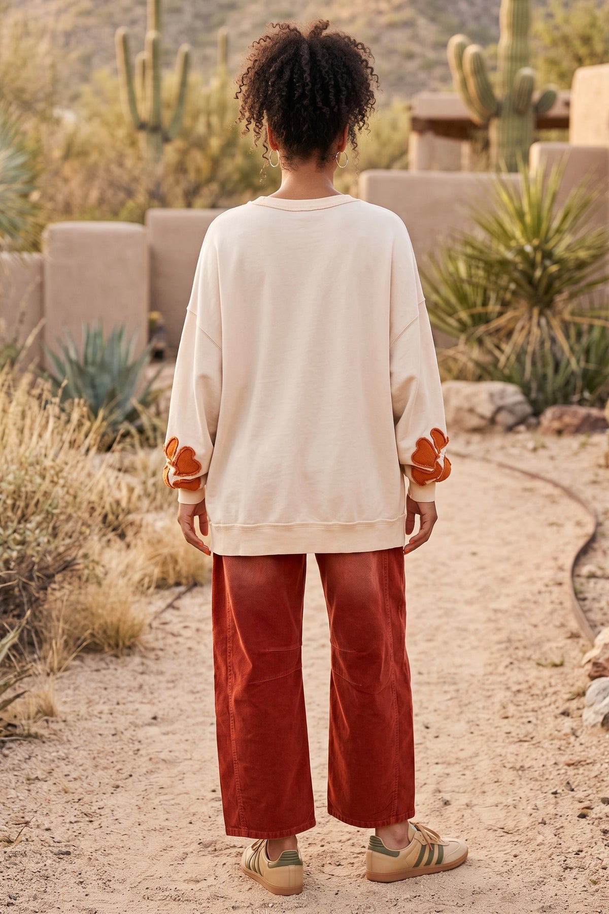 Oversized cotton ivory pullover back view with drop shoulder and orange sleeve flowers in the desert