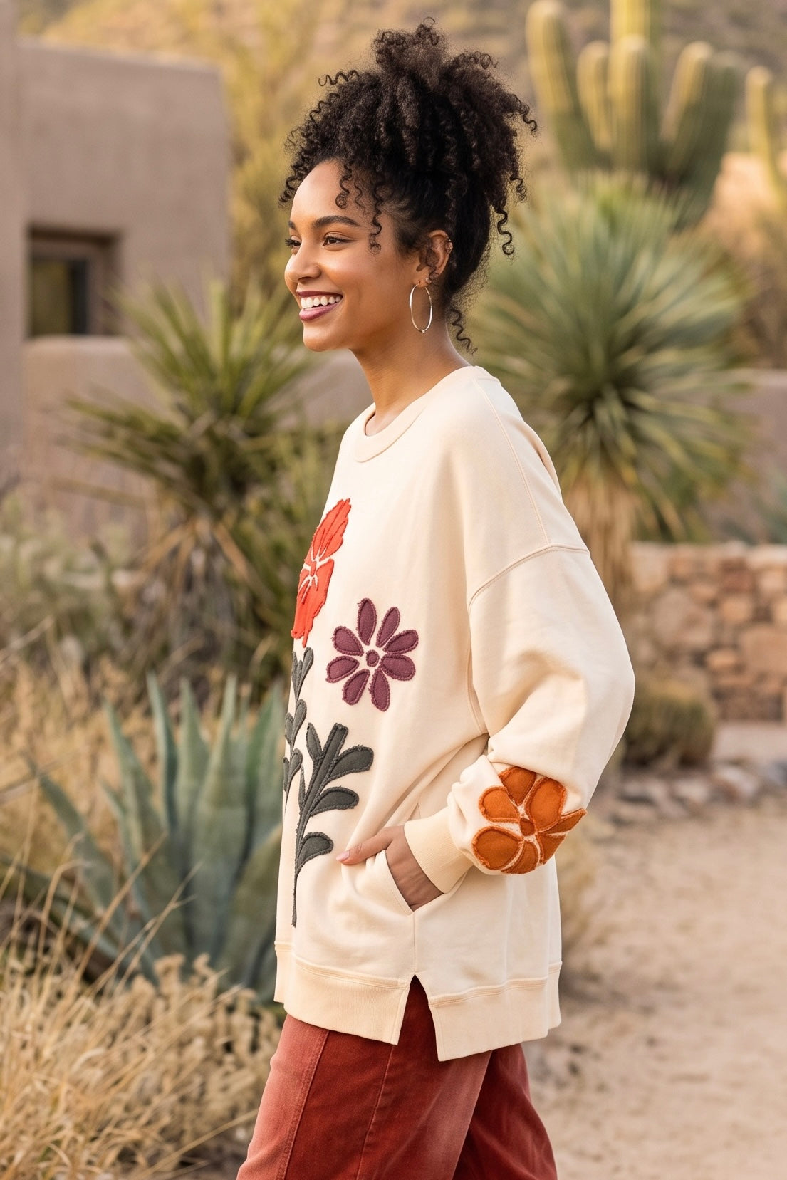 Flower patchwork sweatshirt side profile with plum bloom, olive stem, side slit and ribbed hem