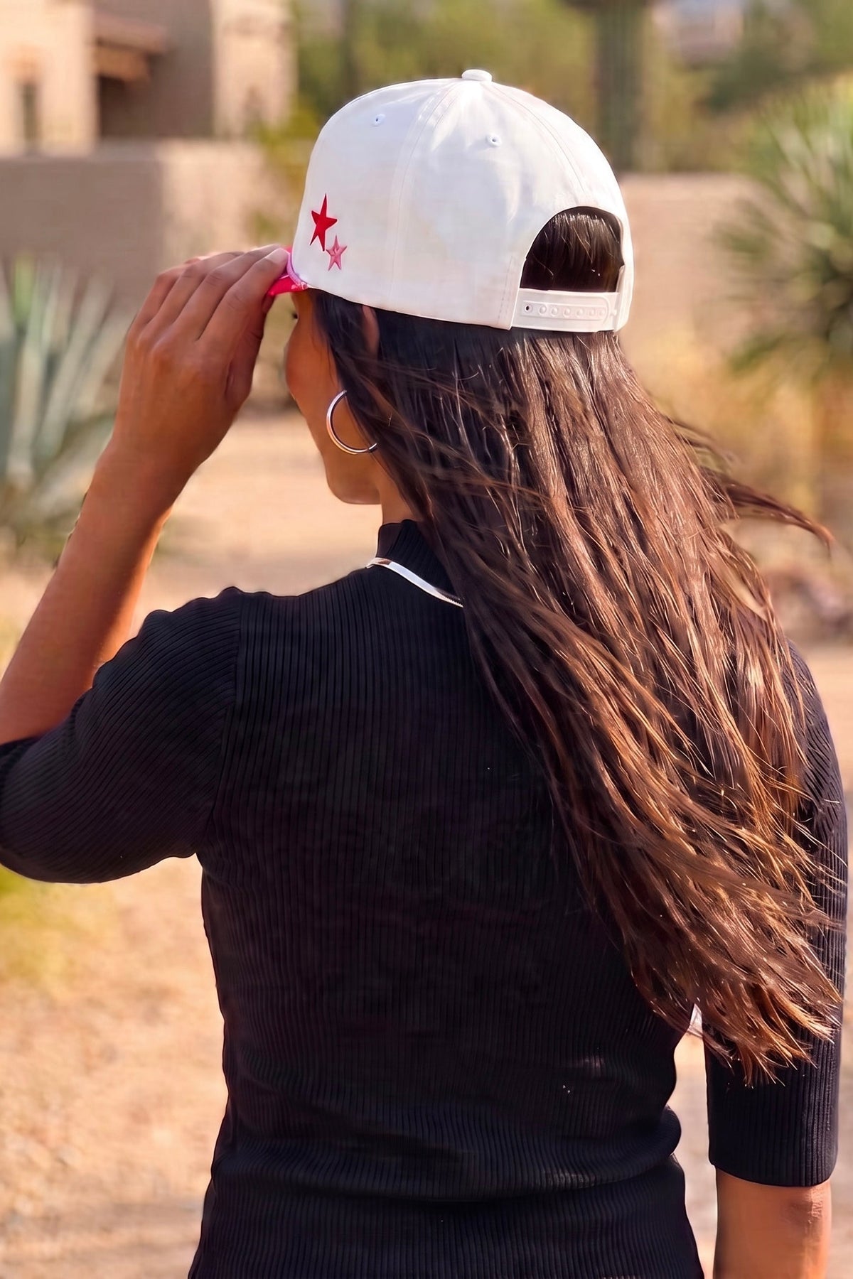 White Christmas trucker hat from behind showing the snapback strap and red and pink side stars